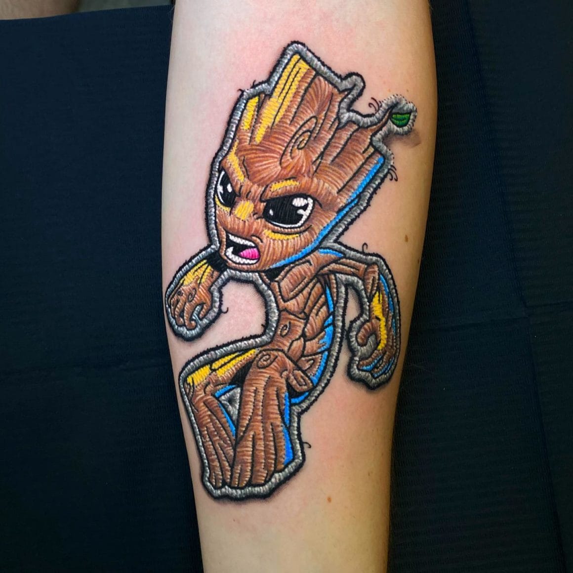 Sur ce tatouage est représenté Groot, l'un des personnages de Marvel.