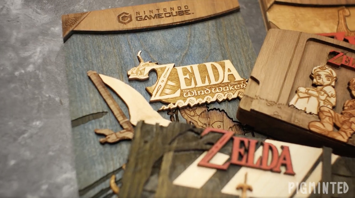 Plusieurs sculptures en bois empilées. Représentant une pochette de Nintendo Game Cube en bois du jeu Zelda,  une cartouche de Game Boy en bois du jeu Zelda et bien d'autres.