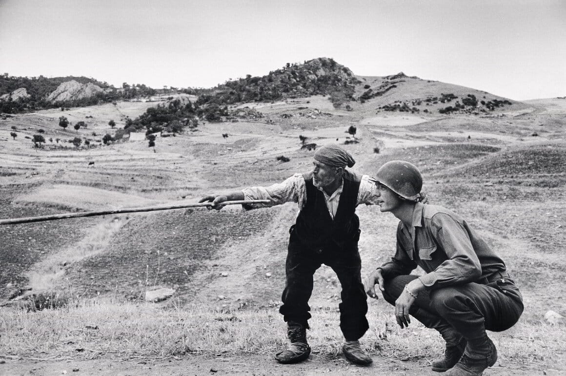 Un paysan sicilien indique à un officier américain la direction prise par les Allemands, près de
Troina en Sicile, Italie, Août 1943
Crédit : Robert Capa/
International Center of Photography/Magnum Photos
