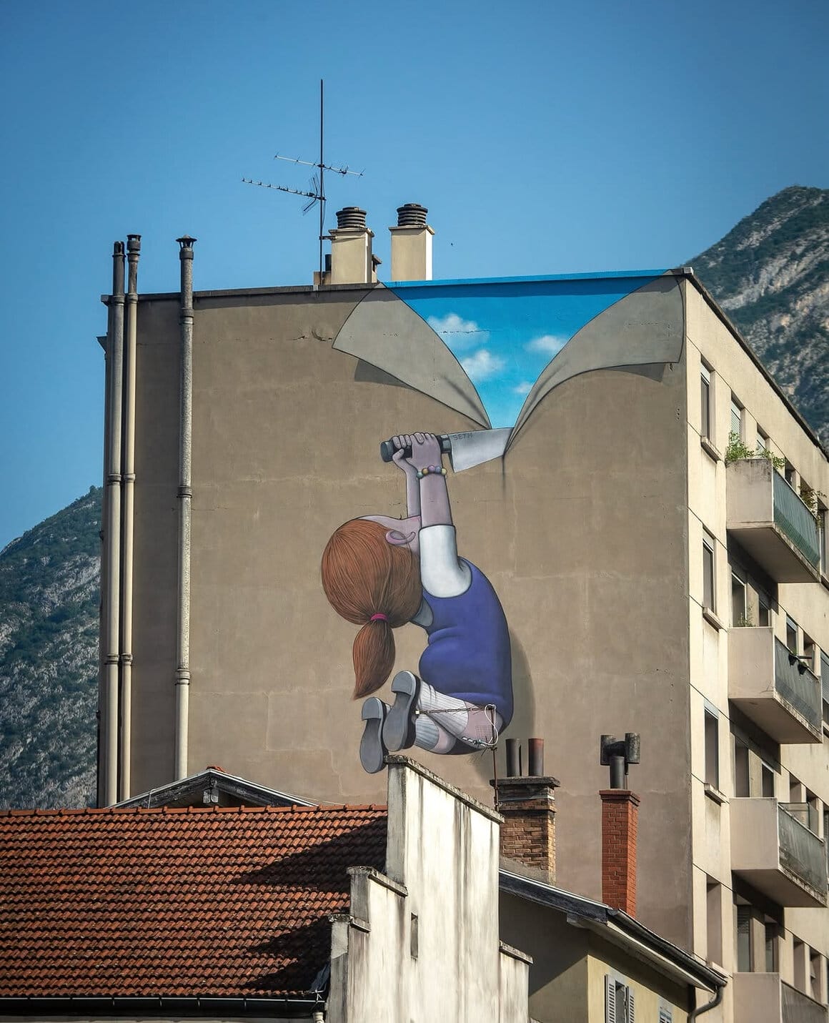 Graphe d'une petite fille découpant le mur pour dévoile le ciel par Seth à Grenoble