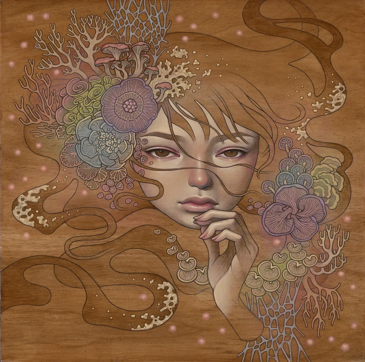 Le visage d'une femme entouré de coraux, de fleurs et de formes marines dont les contours se prolongent sur le bois apparent.
